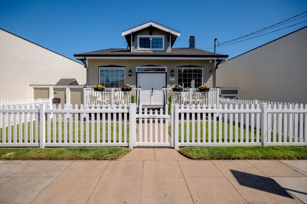 Front exterior outside the gate at 917 Howard Avenue in the Lyon Hoag neighborhood in Burlingame.