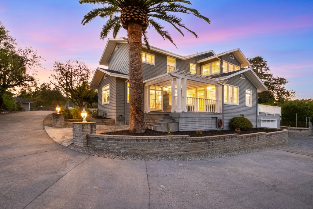 Twilight exterior with palm tree at 681 Upland Road in Redwood City.