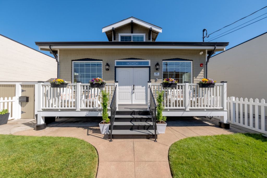Front exterior with grass area at 917 Howard Avenue in the Lyon Hoag neighborhood in Burlingame.